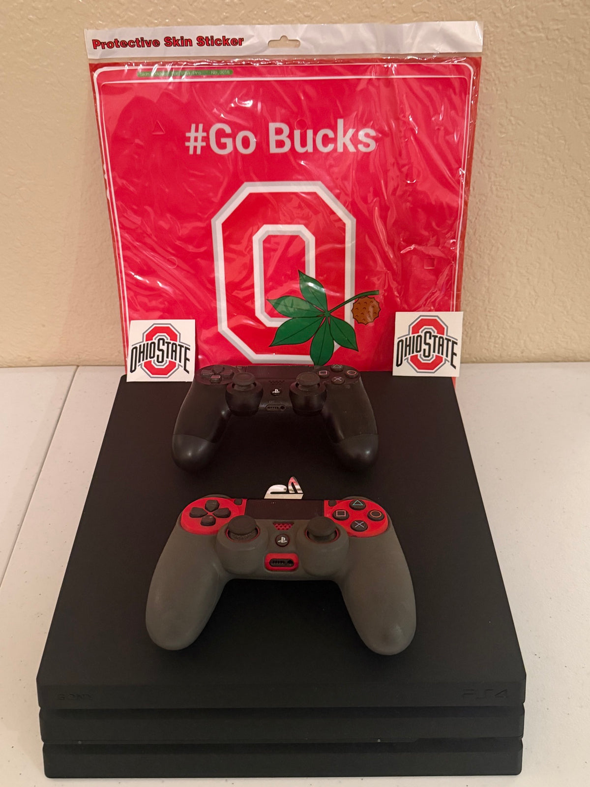 Console with controllers and Ohio State vinyl skin